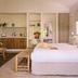 Atlantic Byron Bay guest room with king bed, kitchenette, bench seating and window blinds in Byron Bay