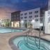 Wyndham Anaheim Hotel in Anaheim with outdoor pool and hot tub at dusk