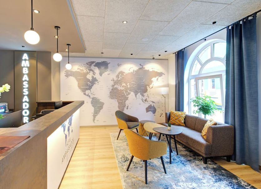 Ambassador Thecontinents Karlsruhe lobby with seating, world map wall and arched window