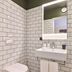 Kex Reykjavík bathroom with wall-mounted toilet, sink, mirror and white subway tile in Reykjavik