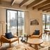 The Junto in Columbus: airy suite with skyline views, wood beams, lounge chairs and dining table