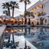 Le Mirage in Bormes-les-Mimosas with palm-lined pool terrace and white hotel exterior at dusk