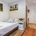 Unikat Guest Rooms Krakow bedroom with single bed, nightstand, artwork, and hallway view