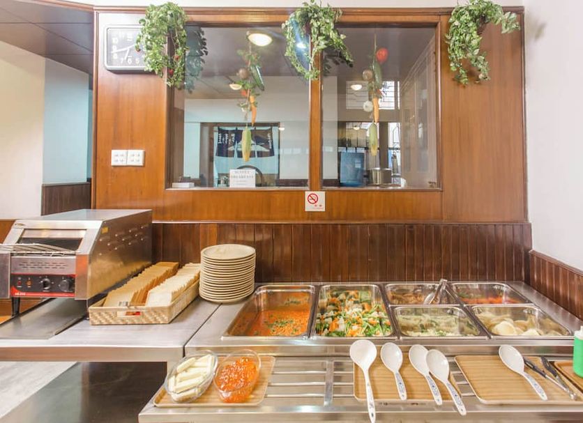 Fuji Hotel Kathmandu breakfast buffet with trays of hot food, bread, plates, and serving utensils