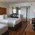 Studio 1 Motel in Daytona Beach guest room with two beds, desk, TV, and wood-look flooring