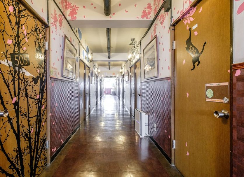 Yokohama Hostel Village Hayashi-Kaikan hallway in Yokohama with cherry blossom-themed doors
