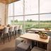 Van Der Valk Hotel Ara in Zwijndrecht dining area with large windows and countryside view