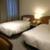 Alley Hotel Hiroshima Namikidori in Hiroshima with two twin beds and bedside lamp in a guest room
