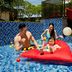 Four Points by Sheraton Surabaya, Tunjungan Plaza pool with slide and family on red float, Surabaya
