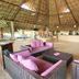 Hotel Villa Mercedes Palenque lobby lounge with thatched roof and purple seating in Palenque
