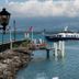 Hotel Restaurant Du Port in Yvoire with a lakeside pier and ferry on calm water