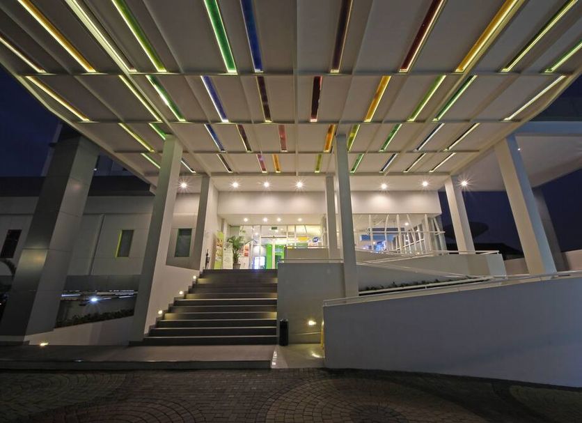 Pop! Hotel Kemang Jakarta entrance at night with lit canopy, steps, and modern white exterior in Jakarta
