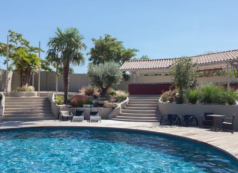 The Originals Boutique, Hôtel La Grange, Niort poolside terrace with loungers and palm trees