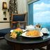 Cherry Maryski Hotel Alexandria room with breakfast table and sea view through window
