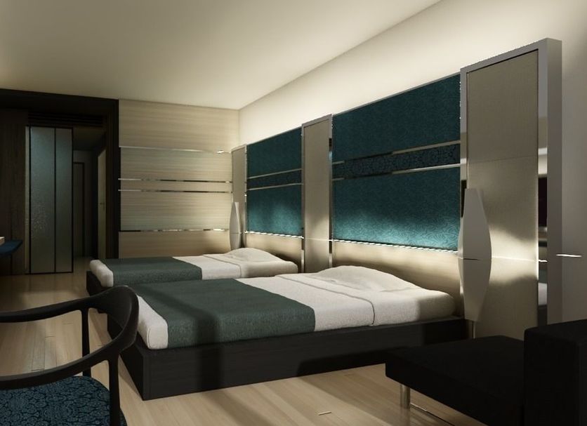 Alvarez Hotel in Buri Ram guest room with modern bed, desk, and teal upholstered wall panels