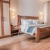 Charlie's El Nido managed by HII guest room with wooden bed, bedside lamps and floor-to-ceiling curtains