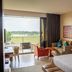 VOGO Abu Dhabi Golf Resort & Spa guest room with balcony golf course view and seating area in Abu Dhabi