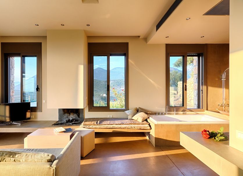 Euphoria Estate Messinia in Avia with a sunlit suite, mountain views, sofa and fireplace