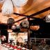 Hotel Peten in Flores: open-air terrace dining with hanging lights and nighttime lake views