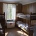 Charlottsborgs Vandrarhem in Kristianstad: wood-paneled room with two bunk beds and a window