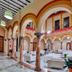 Hotel Palacio Marqués de Arizón lobby with arched columns and white seating in Sanlúcar de Barrameda