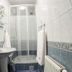 Hotel Góralski Raj bathroom in Nowy Targ with shower, sink, mirror and tiled walls