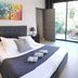 Hpc Suites in Cassis bedroom with king bed, abstract wall art, and sliding doors to a terrace