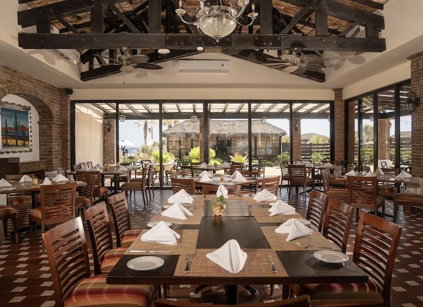 Solmar Resort in Cabo San Lucas dining room with large windows and patio view