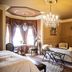 Belle View Manor Inn Harbour Grace guest room with chandelier, fireplace, sitting area and TV