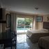 Hotel Graham Villahermosa guest room with two beds and pool view through sliding glass door