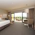 The Barn Accommodation in Mount Gambier guest room with king bed and sliding glass doors to outdoor seating