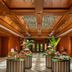 Anantara Xishuangbanna Resort lobby with buffet tables and ornate wood-paneled ceiling in Xishuangbanna