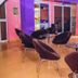 Golden Key Hotel Accra lounge with velvet chairs and round glass tables in a colorful seating area