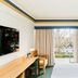 Statesman Hotel Canberra guest room with balcony view, desk, TV and bed