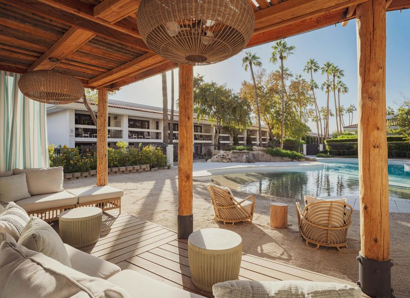 The Scott Resort & Spa Scottsdale poolside cabana with loungers and palm trees