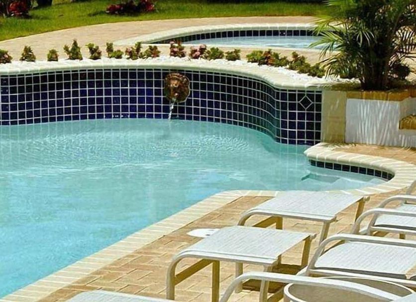Dos Angeles del Mar Bed and Breakfast in Rincon, pool with tiled edge and lounge chairs