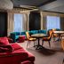 Mercure Chisinau Center Jazz Hotel lounge with velvet seating, round tables and a bar in Chisinau