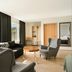 Hotel Katla by Keahotels in Vik, living area with large windows, armchairs and sofa
