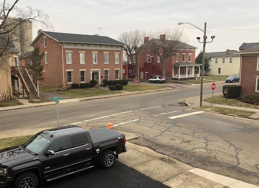 The Guest House in Circleville exterior street view with brick buildings and parked pickup truck