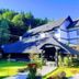 Casa Octavian in Suceviţa with a sloped-roof lodge, landscaped garden, and forest backdrop