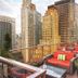 Rooftop terrace at Wyndham Midtown 45 in New York with red lounge seating and city skyline views