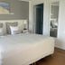 Hotel Strandly Skagen guest room with double bed, bedside lamps, and mirror in Skagen