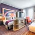 Leonardo Hotel Munich City South room in Munich with twin beds, TV divider, and floor-to-ceiling windows