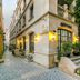 Deniz Inn Boutique Hotel in Baku, street-facing entrance with lit lanterns and potted plants