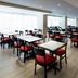 Residence Inn by Marriott Montreal Downtown breakfast area with rows of tables and red chairs