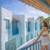 Resort De Paskani in Hua Hin balcony view with blue-and-white buildings and a woman overlooking the resort
