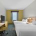 Best Western Wesley Chapel guest room with two beds, desk, chair, and window