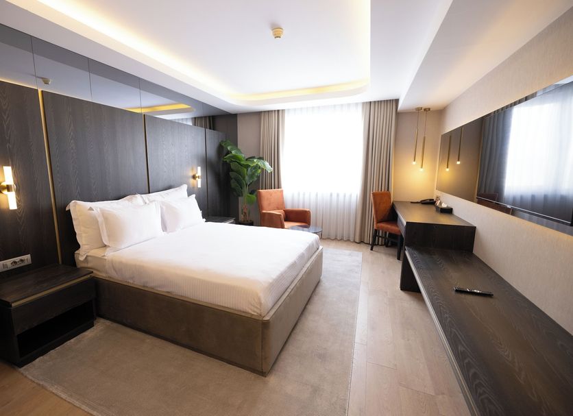Bilkent Hotel and Conference Center Ankara guest room with king bed, desk, seating area and large window