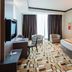 Grand Paragon Hotel Johor Bahru room with king bed, seating area, and patterned carpet in Johor Bahru