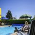 ibis Belfort Danjoutin poolside terrace with outdoor pool and lounge chairs in Danjoutin